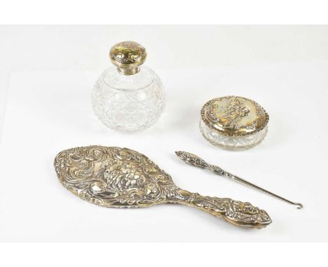 A hallmarked silver dressing table set with various hallmarks, each with embossed cherub decoration, comprising scent bottle,