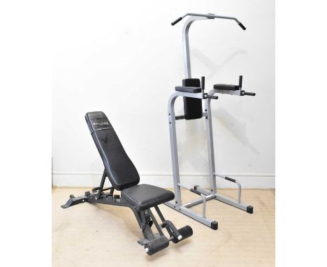 BODY-SOLID; an adjustable weight bench with assorted dumbbells and a multigym frame with pull-up bar and squat bars.