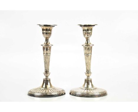 HARRISON BROTHERS &amp; HOWSON; a pair of late Victorian hallmarked silver candlesticks of oval form, with gadrooned decorati