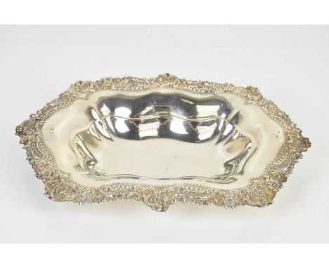 A hallmarked silver bowl of shaped oval form, with a cast decorated border, marks rubbed, length 30cm, approx 10ozt/311g.