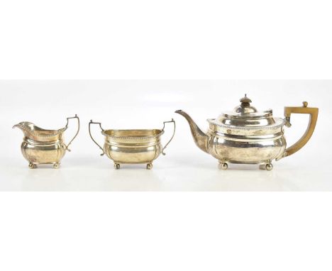 HARRODS LTD; a George V hallmarked silver three piece tea service with cast rim, London 1929, combined approx 32.5ozt/1011g (