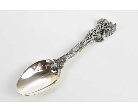 G RASPINI; an 800 grade silver serving spoon, with cast handle decorated with shells and seedweed, length 28cm, approximate w