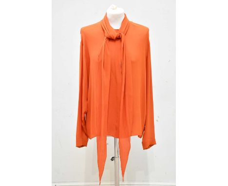 HERMÈS; a 100% silk orange blouse, with tie neck detail and long sleeves, with mother of pearl buttons to sleeves and branded