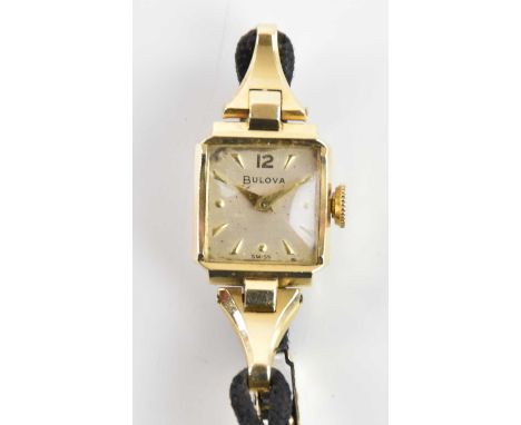 BULOVA; a lady's vintage 14ct yellow gold wristwatch, with baton markers to the square dial, part fabric bracelet with adjust