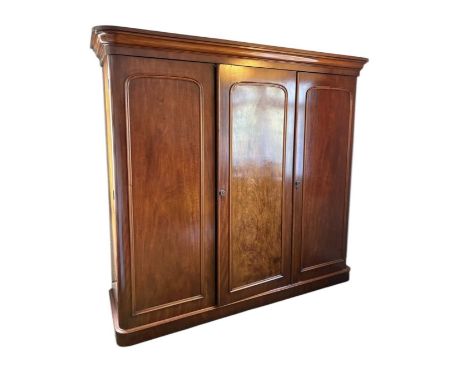 A Victorian mahogany three door wardrobe with part fitted interior, height 210cm, width 228cm, depth 67cm.