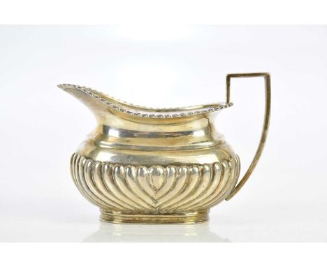 MAPPIN &amp; WEBB; a George V hallmarked silver cream jug, with gadrooned lower body, Sheffield 1912, approx 3.8ozt/119g.