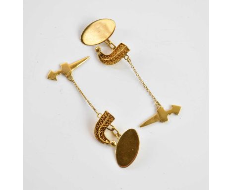A pair of yellow metal cufflinks, each with oval vacant platform and with the reverse modelled as an Eastern kadjar and worki