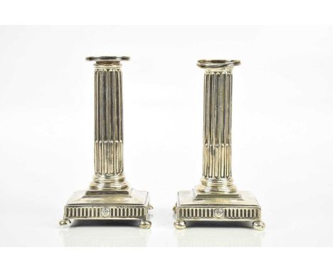 A pair of Georgian hallmarked silver fluted column taper sticks, on ball feet, London (marks rubbed), height 16cm, (weighted)