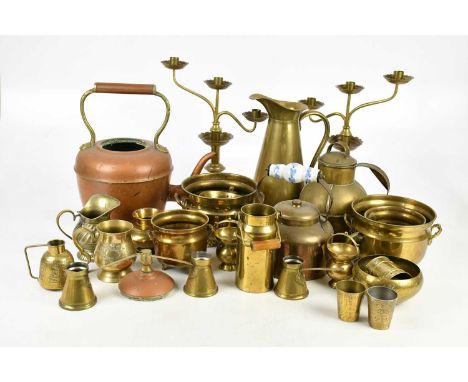 A mixed collection of copper and brassware, including kettles, jugs, a pair of candlesticks, also a set of cast iron scales (