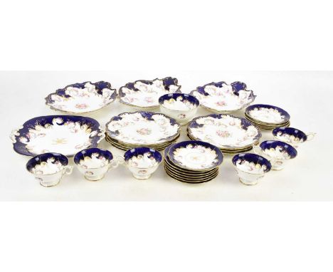 COALPORT; a ten piece part dessert service, decorated with floral sprigs against a blue and gilt ground, and a similar twenty