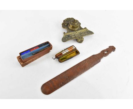 A brass inkwell, a hallmarked silver mounted cheroot holder, a brass cased propelling pencil and a page turner (4).