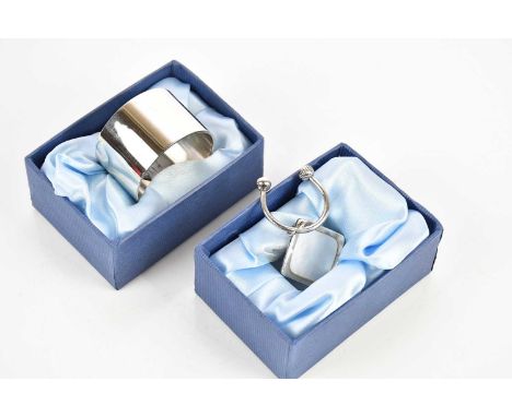 DOUGLAS PELL SILVERWARE; an Elizabeth II hallmarked silver and mother of pearl keyring, London 2005, and a hallmarked silver 