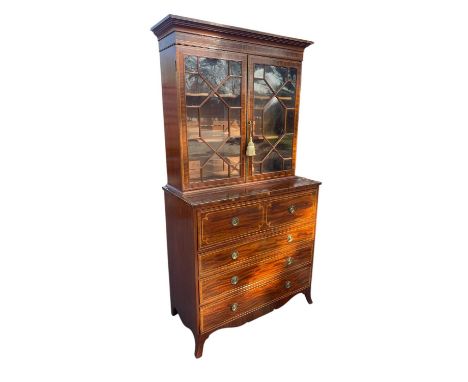 A 19th century inlaid mahogany secretaire bookcase, with two astragal glazed doors above a fitted drawer and three graduated 