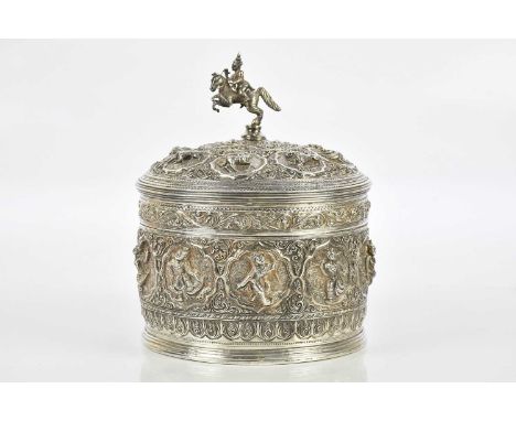 A Burmese white metal betel box, decorated with deities and animals, height 23cm, diameter 19cm, approx 56.21ozt/1748g.   Con