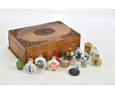 A small collection of Chinese snuff bottles including resin, hardstone, ceramic and glass examples, in wooden box.