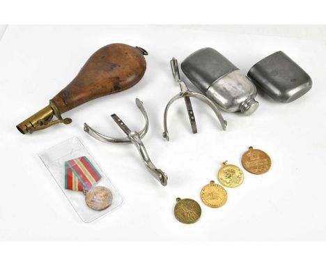 A collection of assorted militaria including Russian medallions, pewter hip flask, powder flask, stirrups. 
