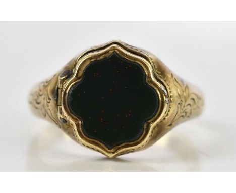 A 19th century yellow metal portrait ring, with hinged bloodstone set shaped platform revealing the painted portrait of a wom