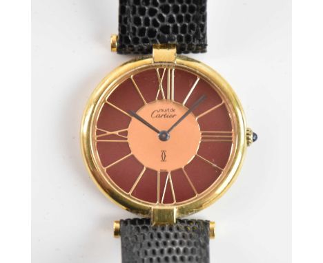 CARTIER; a lady's Must de Cartier silver gilt quartz wristwatch, with baton markers and Roman numerals to the circular dial, 