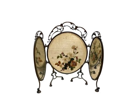A Victorian ornate brass triptych firescreen with mirrored panels, the central example with floral decoration, height 72cm.