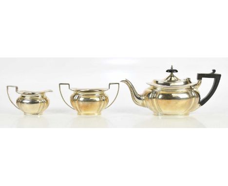 JAMES DEAKIN &amp; SONS; a George V hallmarked three piece bachelor tea service of oval form, Sheffield 1926, approximate wei