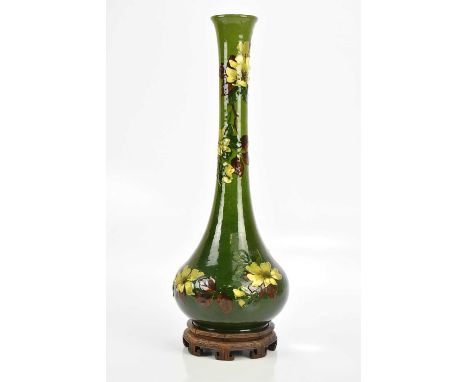 BURMANTOFTS; a faience green ground floral decorated vase, stamped to the underside of the base, height 50cm, with associated