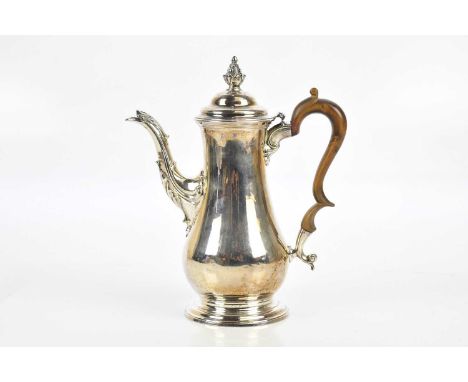 SAMUEL WHITFORD I; a George II hallmarked silver pear shaped coffee pot, with pineapple finial and engraved family crest, Lon