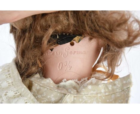 A German bisque headed doll with articulated body, length 46cm.