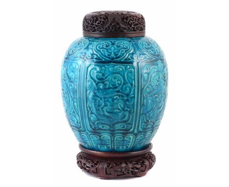 Chinese vase, the turquoise glazed body moulded with dragons and scrollwork, together with pierced hardwood lid and stand, Ka