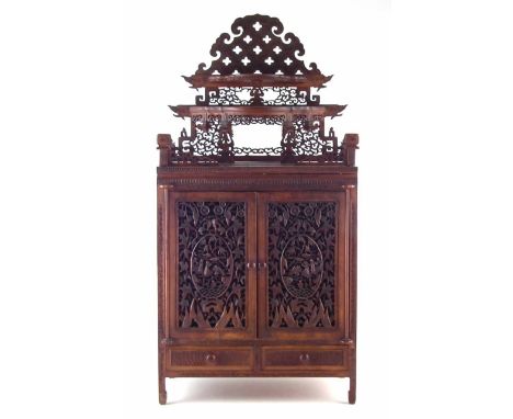 Chinese hardwood table top cabinet, with pierced relief carved shelf frieze, two pierced doors revealing eight doors above an