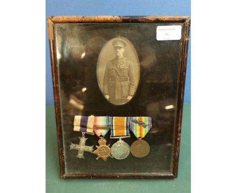 Leather easel framed and mounted MC WWI group of medals awarded to Major W.M.Biden, a display with circular black &amp; white