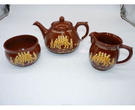A Dartmouth pottery tea pot, milk jug, sugar basin with Widdecombe fair decoration.