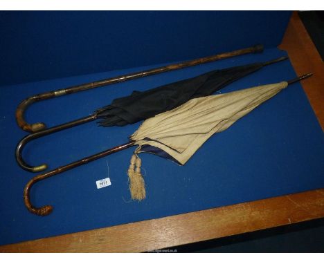 Two fabric Parasols, one with bamboo handle, and a walking stick with a silver band, London (indistinct date), makers J.H.