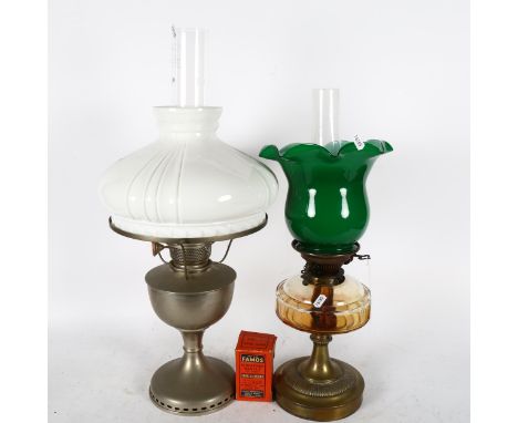 An oil lamp with chimney and milk glass shade, height 62cm, and another oil lamp, with glass font and green glass shade 