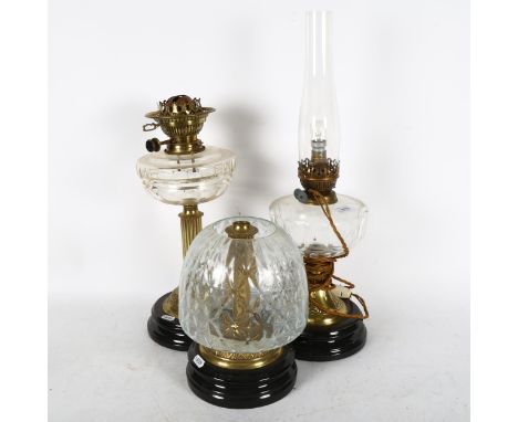 A group of 3 lamps, including an embossed brass oil lamp with cut-glass font and chimney, height 55cm 