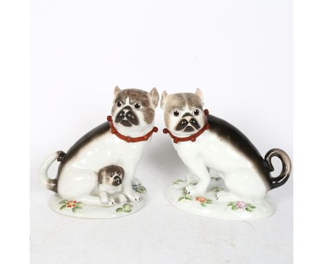 A pair of German ceramic Pugs, on floral decorated bases, height 19cm 