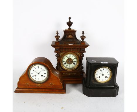 An Edwardian mahogany mantel clock, a Victorian black slate clock, and a walnut-cased 14-day striking clock (3) 