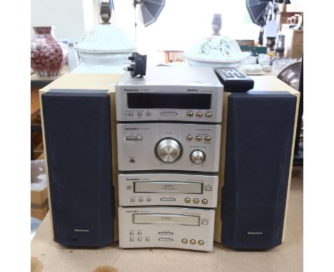 A Technics stacking stereo system, with CD and tape deck, amplifier and tuner, with remote control 