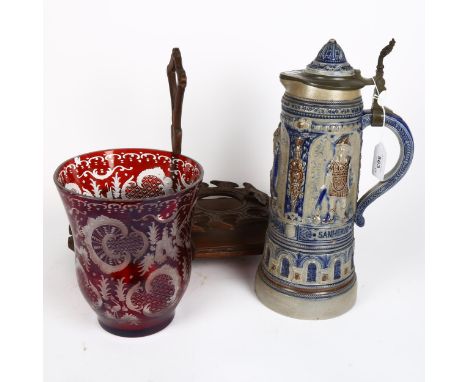 A Black Forest decanter stand, a tall Rhine Ware beerstein, and an etched ruby glass vase 