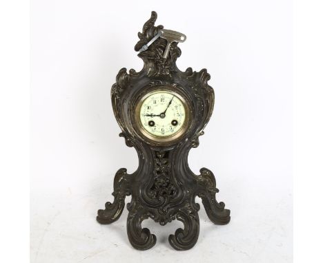 A Victorian patinated spelter mantel clock in Rococo style, with 8-day striking movement and key, height 40cm 