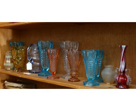 A shelf of 1930s moulded glass vases, jugs etc 