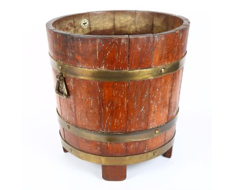 R A LISTER &amp; CO LTD - a brass coopered oak jardiniere, diameter 36cm, height 38cm 