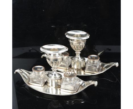 A Victorian silver plate on copper desk stands of shaped form, with fitted candlestick, glass inkwell and sander, length 25cm