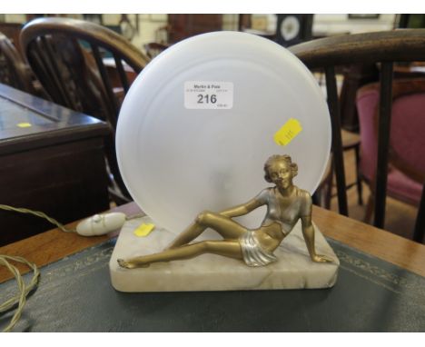 An Art Deco marble table lamp, with gilded figure of a recumbent lady 20cm long