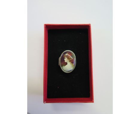 A silver oval pill box with an enamel portrait of a lady