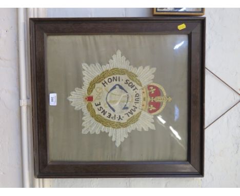 An early 20th century silk embroidered military badge for the Army Service Corps, 43cm x 40cm