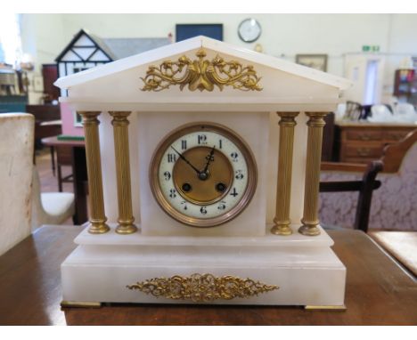 A late Victorian alabaster mantel clock, of architectural form with gilt metal mounts, the twin train movement striking on a 