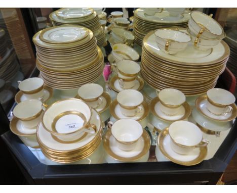 A matched set of Mintons and Royal Worcester dinner and coffee wares, all with gilt bands and ivory borders