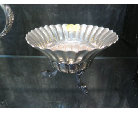 A Chinese export silver dish or bowl with three dolphin head feet, 12cm diameter