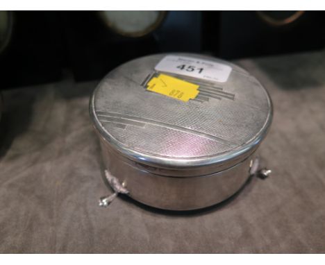 A round silver trinket box with engine turned decoration on three feet