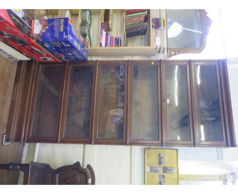 A stained oak Globe Wernicke style stacking bookcase, the six graduated shelves with glass fall fronts on a moulded base, 87c